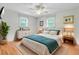 Bedroom with natural light from two windows, ceiling fan, and light wood floors at 106 Newington Rd, Summerville, SC 29485