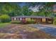 Charming brick home with mature trees and a well-maintained front yard at 106 Newington Rd, Summerville, SC 29485