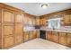 Well-lit kitchen featuring wood cabinets, countertops, and tile flooring at 106 Newington Rd, Summerville, SC 29485