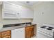 Efficient kitchen with white appliances, wood cabinets, and a stainless steel sink at 106 Newington Rd, Summerville, SC 29485