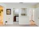 An open kitchen area with white cabinets and appliances adjacent to a living space at 106 Newington Rd, Summerville, SC 29485