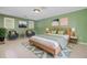 Calm main bedroom with hardwood bed frame, soft blue accents, and ample natural light at 106 Newington Rd, Summerville, SC 29485