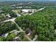 Aerial view showcasing a home nestled among trees with surrounding neighborhood and amenities at 109 Holly St, Summerville, SC 29485