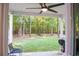 Back porch with ceiling fan providing views of a private backyard and wooded scenery at 109 Holly St, Summerville, SC 29485