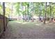 Spacious backyard bordered by a wooden fence and mature trees for privacy at 109 Holly St, Summerville, SC 29485