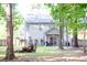 View of the back exterior of a two-story home with a wooded backyard at 109 Holly St, Summerville, SC 29485
