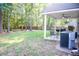 Private backyard features a covered back porch, grill, and wooded boundary at 109 Holly St, Summerville, SC 29485