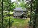 Scenic backyard view with a covered patio, manicured lawn, and mature trees providing privacy at 109 Holly St, Summerville, SC 29485