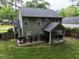 Backyard view featuring a covered patio, manicured lawn, and mature landscaping at 109 Holly St, Summerville, SC 29485