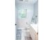 Bright bathroom featuring tile floor, white cabinets, and natural light from the window at 109 Holly St, Summerville, SC 29485