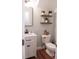 Charming half bath featuring a vanity with framed mirror, wall decor, and classic toilet at 109 Holly St, Summerville, SC 29485
