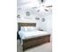 Bright bedroom with a dark wood bed frame and fan, decorated with stylish art at 109 Holly St, Summerville, SC 29485
