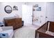 Stylishly decorated Bedroom with a changing table, round rug, and a cozy looking modern crib at 109 Holly St, Summerville, SC 29485