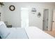 Bright bedroom features neutral walls, a decorative wall clock, and view into a bathroom at 109 Holly St, Summerville, SC 29485