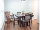 Well-lit dining area with hardwood floors featuring a wooden rocking chair and stylish table set at 109 Holly St, Summerville, SC 29485