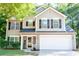 Charming two-story home with a manicured lawn, a two-car garage, and classic architectural details at 109 Holly St, Summerville, SC 29485
