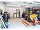 Spacious garage with storage shelves, refrigerator, utility sink, and ride on mower at 109 Holly St, Summerville, SC 29485