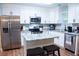 Modern kitchen with white cabinets, stainless steel appliances, and island with marble countertops at 109 Holly St, Summerville, SC 29485