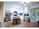 Bright kitchen with white cabinets, stainless steel appliances, island, and sliding door to the back patio at 109 Holly St, Summerville, SC 29485