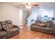 Open-concept living space with sleek hardwood floors leading into the kitchen with modern appliances and white cabinetry at 109 Holly St, Summerville, SC 29485
