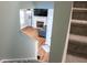 View from the top of the stairs of a living room featuring a cozy fireplace and hardwood flooring at 109 Holly St, Summerville, SC 29485
