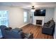 Inviting living room with fireplace, ceiling fan, hardwood floors and comfortable grey reclining sofa and chairs at 109 Holly St, Summerville, SC 29485