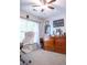 Well lit home office features a large window with a comfortable looking white chair and desk at 109 Holly St, Summerville, SC 29485