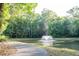 Scenic pond with a fountain, bordered by lush trees and a paved walking trail at 109 Holly St, Summerville, SC 29485