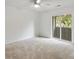 Light-filled bedroom with plush carpeting and sliding glass doors to a private balcony at 1142 Village Creek Ln # 4, Mount Pleasant, SC 29464
