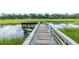 Wooden dock extending into the marsh, offering a peaceful retreat and panoramic views of the surrounding landscape at 1142 Village Creek Ln # 4, Mount Pleasant, SC 29464