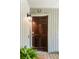 Stunning front door with decorative horseshoe, light fixture and welcome mat offers a warm entrance to this charming home at 1142 Village Creek Ln # 4, Mount Pleasant, SC 29464