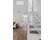 Hallway with white stairs and wood look floors at 1142 Village Creek Ln # 4, Mount Pleasant, SC 29464