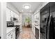 Modern kitchen with white cabinets, stainless steel appliances, and view into a charming dining area perfect for entertaining at 1142 Village Creek Ln # 4, Mount Pleasant, SC 29464