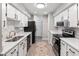 Galley kitchen with white cabinets, modern appliances, and stylish finishes creates a sleek and functional cooking space at 1142 Village Creek Ln # 4, Mount Pleasant, SC 29464