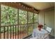 Relaxing screened patio with string lights and a small table overlooking lush greenery at 1142 Village Creek Ln # 4, Mount Pleasant, SC 29464