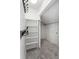 A carpeted walk-in closet with built-in shelving and coat hooks to provide ample storage space at 1142 Village Creek Ln # 4, Mount Pleasant, SC 29464