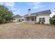 A spacious backyard with a fenced area, a screened-in porch, and pine trees at 1171 Hammrick Ln, Johns Island, SC 29455