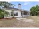 A rear view of home with a screened in porch and pine trees in a large back yard at 1171 Hammrick Ln, Johns Island, SC 29455
