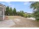 Large backyard featuring a lake view, pine trees, and a concrete patio at 1171 Hammrick Ln, Johns Island, SC 29455