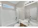 A full white bathroom with a tub and shower, a sink with vanity and a large mirror at 1171 Hammrick Ln, Johns Island, SC 29455