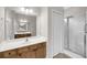 Full bathroom featuring dual vanity sinks, large mirror, walk-in shower with glass door and neutral tile at 1171 Hammrick Ln, Johns Island, SC 29455