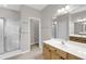 Bright bathroom featuring double sink, walk in shower with glass door and neutral tile at 1171 Hammrick Ln, Johns Island, SC 29455