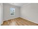 A well-lit bedroom with hardwood floors and a bright window with white blinds at 1171 Hammrick Ln, Johns Island, SC 29455
