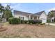 Well-manicured front lawn featuring trimmed shrubs with a view of the charming home at 1171 Hammrick Ln, Johns Island, SC 29455
