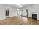Spacious living room featuring hardwood floors, a ceiling fan, and a cozy fireplace at 1171 Hammrick Ln, Johns Island, SC 29455