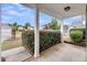 View from the porch of this home surrounded by landscaped hedges and green lawn at 1171 Hammrick Ln, Johns Island, SC 29455