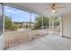 A screened porch with a ceiling fan and a beautiful view of the lake and backyard at 1171 Hammrick Ln, Johns Island, SC 29455