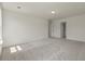 Large bedroom with neutral carpet, bright windows, and access to en-suite bathroom at 120 Shingle Oak Dr, Moncks Corner, SC 29461