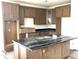 Spacious kitchen featuring an island with dark stone countertops and wooden cabinets at 120 Shingle Oak Dr, Moncks Corner, SC 29461