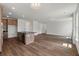 Open-concept living room and kitchen featuring a kitchen island and spacious hardwood floors at 120 Shingle Oak Dr, Moncks Corner, SC 29461